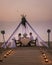 Young couple Honeymoon dinner by candle light during sunset on the beach, men and woman having dinner on the beach