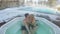 Young couple in hot tub jacuzzi outdoors at winter selfie