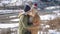 Young couple hugging with beautiful snowy mountains on background.