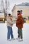 Young couple ice skating together and holding hands in fun winter date