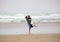 Young couple kissing on beach by ocean on foggy day