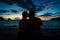 Young couple kissing on a dreamy beach at dusk during summer vacation