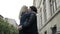 Young couple kissing and embracing spinning around outdoor in the city