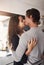 Young, couple and kissing in home for love, romantic bond and intimacy of special moment together. Man, woman and