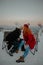 Young couple kissing and sharing their love while sitting on folding chairs on a cold winter day