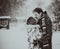 Young couple kissing on snow. Black and white.