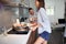 Young couple in kitchen laughing while cooking and drinking coffee.  lifestyle, modern living concept