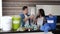 Young couple in kitchen during quarantine. Young man and woman sorting garbage with responsibility. Separating plastic