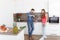 Young couple in kitchen with wine.