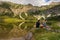 Young couple laughing and having fun in front of a mountain lake / Couple standing in beautiful nature landscape from Bavaria.