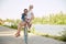 Young couple, laughing, joyful woman and her boyfriend going for a bike ride on a sunny summer day. love, people