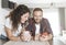 Young couple laughs while using smartphone - couple in love having breakfast together and reading the latest news using mobile pho