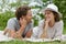 Young couple layed on blanket on grass