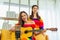 young couple lgbt women live social online and play guitar