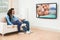 Young couple in livingroom watching television