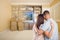 Young Couple Looking At Drawing of Entertainment Unit In Room