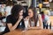 Young couple looking at each other while having drink together in restaurant