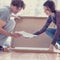 Young couple looking at manual of self assembly furniture