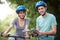 Young Couple Looking At Map Whilst On Cycle Ride