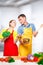 A young couple looks at each other in love while cooking vegetable salad
