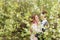 A young couple in love cuddles against the background of blooming spring cherry orchards 1