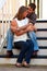 Young Couple In Love Embrace On Steps