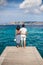 Young couple in love enjoy beautiful sea landscape on pier in It