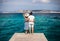 Young couple in love enjoy beautiful sea landscape on pier in It