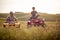A young couple in love enjoys the scenery while riding quads in the nature. Riding, nature, relationship, activity
