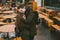 A young couple in love and a girl and a student stand embracing near the tables of a street terrace cafe closed empty without