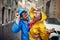 A young couple in love is in a good mood while walking the city during a rain. Walk, rain, city, relationship