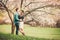 Young couple in love having a date under pink blossom trees.
