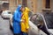 A young couple in love is having romantic moments while walking the city on a rainy day. Walk, rain, city, relationship