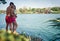 A young couple in love is in hug standing on the dock on the river bank enjoying romantic moments. Summer, love, river, romantic