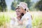 Young couple in love hugging and sitting in the meadow