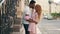 Young couple in love kisses on the street of a European city on a summer day