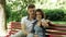 Young couple in love makes selfie on a bench in the park