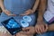 Young couple in love with a pregnant woman holds in their hands a picture of an ultrasound with an unborn baby