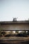 Young couple in love raising their hands on an old bridge