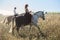 Young couple in love riding a horse