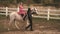 Young couple in love riding a horse. Couple man and woman walking on a ranch with horses.