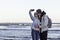 Young couple in love on sea shore taking selfie with mobile phone. Portrait of a romantic couple in love hugging and kissing by th