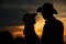 Young couple in love silhouette in cowboy hats