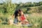 Young couple in love on summer picnic with watermelon. Loving couple sitting by the river, talking, smiling, laughing