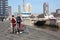 Young couple in love with tourists traveling in rotterdam with their bicycles on an autumn day. visiting the port and the river in