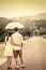 Young couple in love under an umbrella after rain