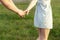 Young couple in love walking in the autumn park holding hands looking in the sunset