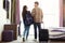 Young couple with luggage in hotel room