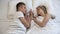 Young couple lying in bed and holding hands, perfect romantic moment, harmony