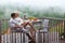 Young couple man and woman - breakfast on the rainy balcony